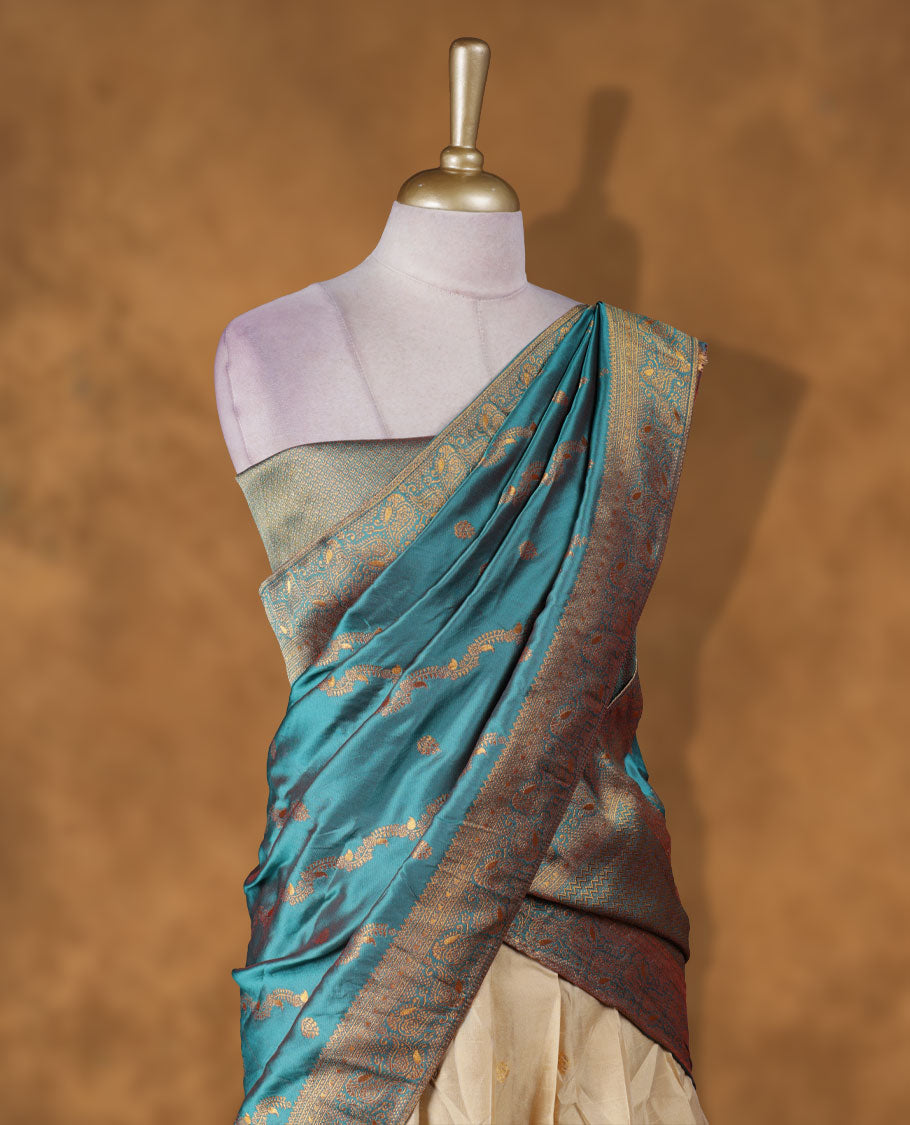 Chic semi stitched dhavani in cream and teal silk with delicate zari motifs and a rich pallu & A perfect choice for traditional celebrations, blending elegance with customizable comfort and grace.