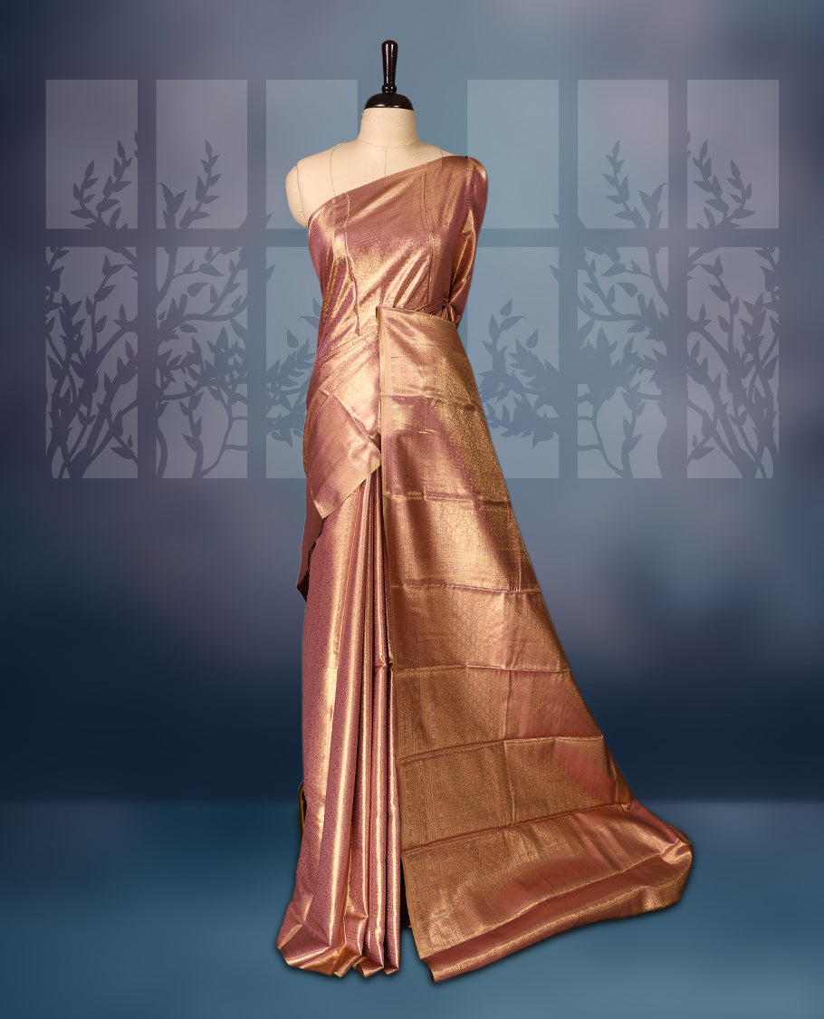 Golden pink colour semi silk brocade saree featuring delicate self brocade motifs across the body, enhanced with a soft gold toned woven border and pallu, Includes a matching blouse for a graceful ethnic look.