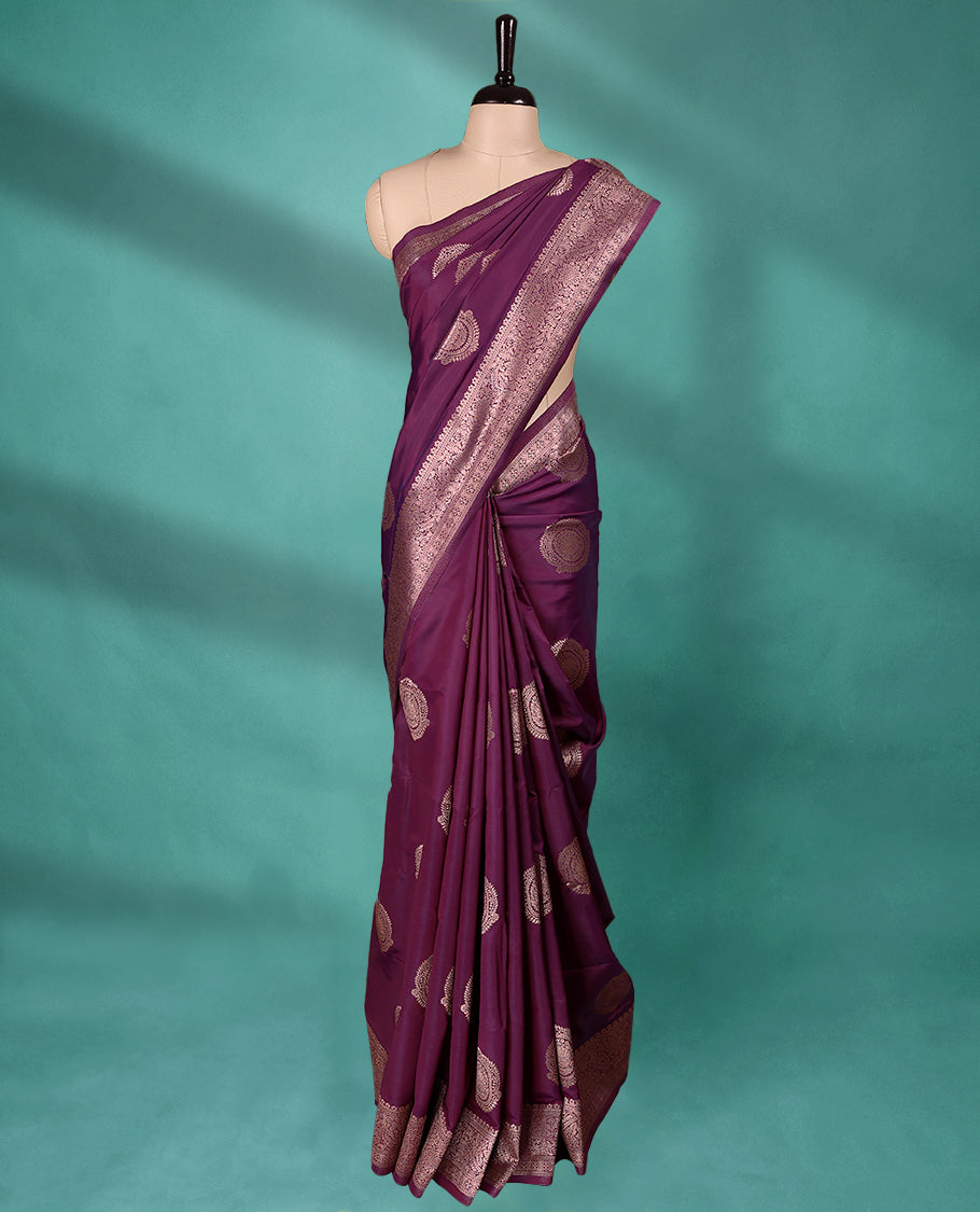 Grape Wine coloured semi silk saree featuring a Golden Zari Butta design on the body, paired with a Self coloured border and matching blouse.