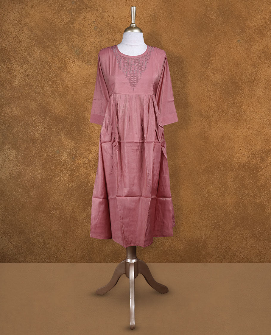 Coral pink colour kurti highlighted with delicate cutwork detailing along the scoop neckline, styled with gathered waist and comfy 3/4th sleeves.