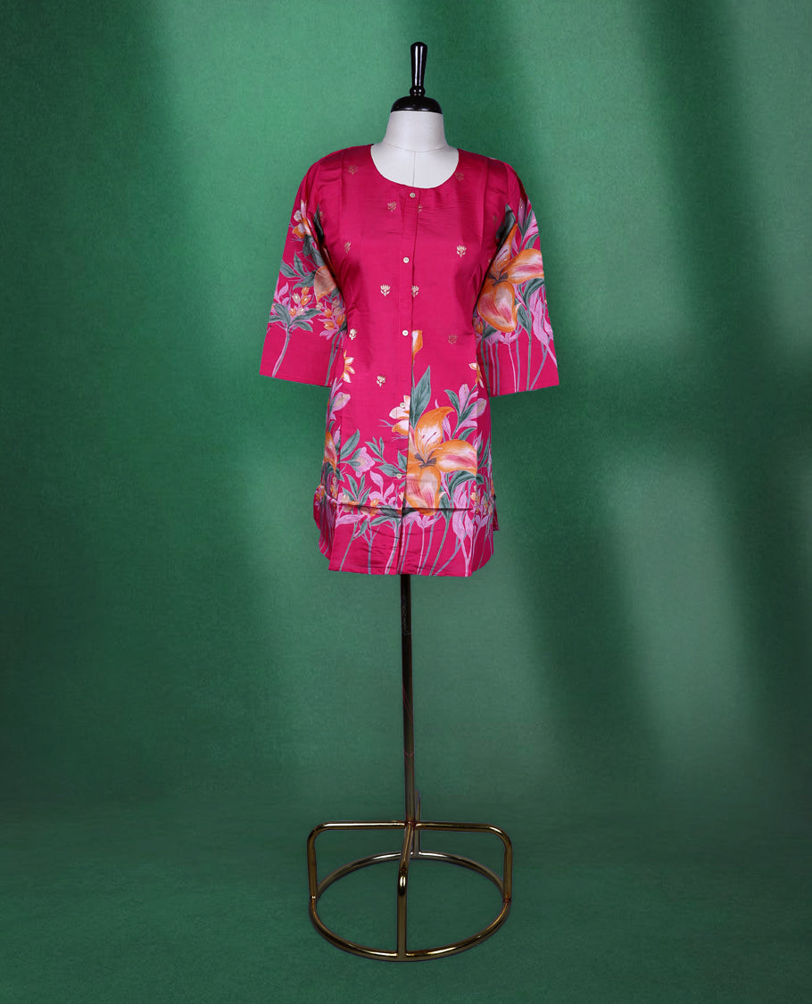 Fuchsia pink colour short kurti featuring a round neck and three quarter sleeves, adorned with vivid orange floral prints and minimal front buttons for a vibrant, breezy look.