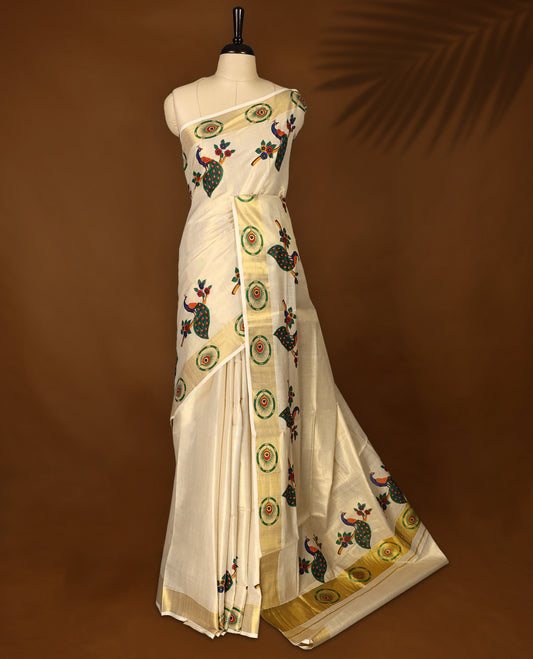 Elegant off-white Kerala cotton saree with vibrant peacock digital prints and a rich golden zari border. Perfect for festive and traditional occasions. Comes with a matching blouse piece.