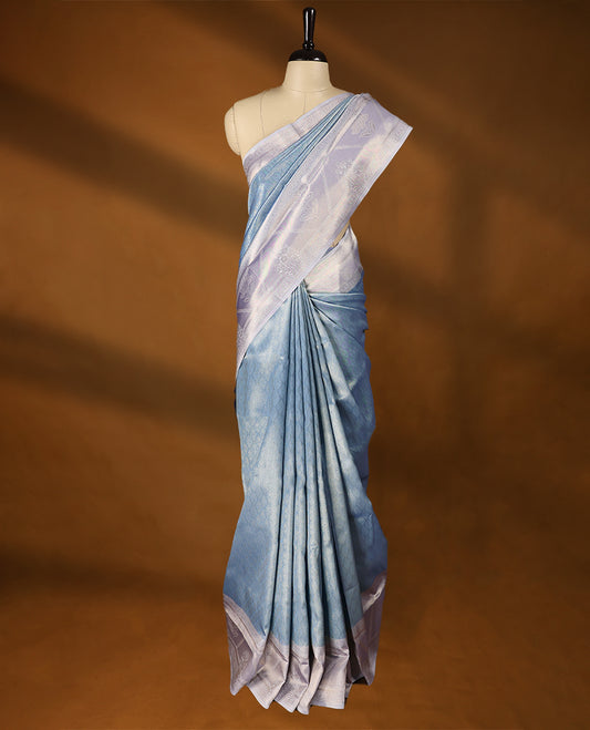 Light Blue coloured semi silk saree featuring a Golden Brocade body, paired with a Light Pastel Purple coloured border and matching blouse.