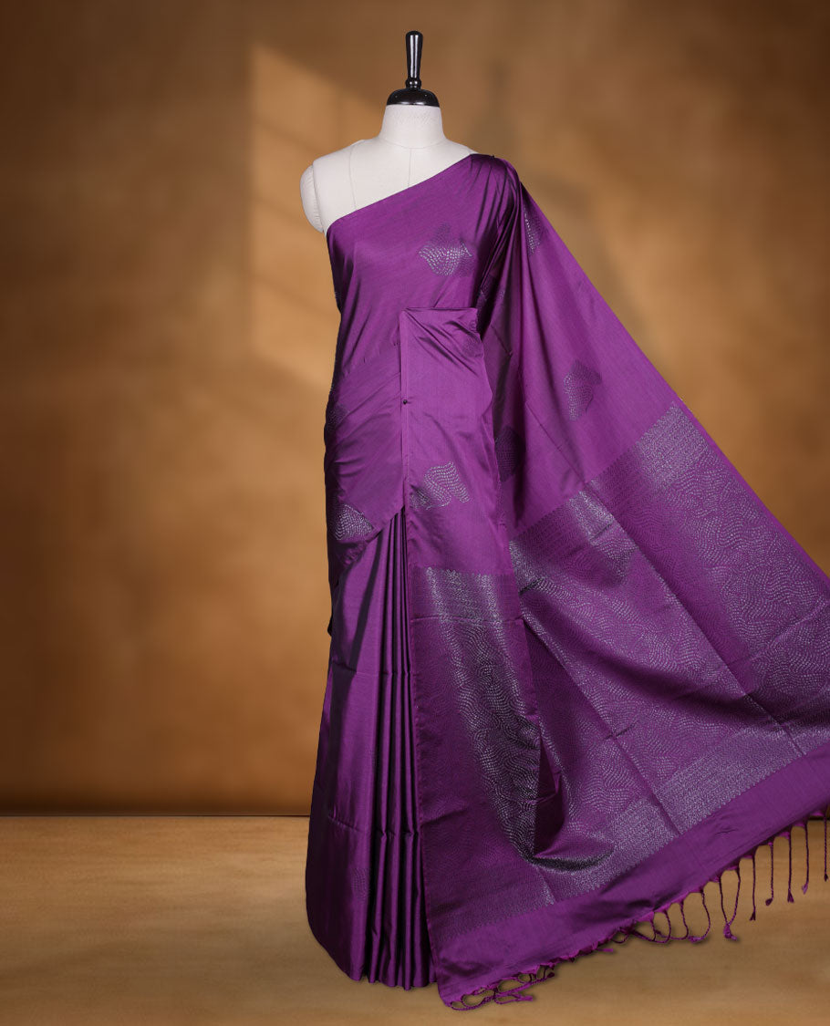 Purple colour semi soft silk saree adorned with delicate woven motifs on the body, complemented by a Self colour woven pallu with intricate detailing and tassel accents without border & Comes with a matching blouse piece.