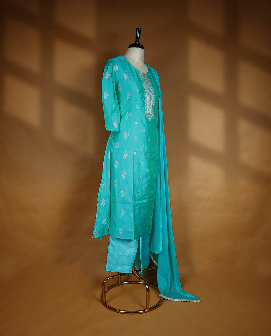 Aqua green colour salwar from TWARA, featuring a round neck adorned with sequins and thread work, with floral prints on the top, paired with a matching bottom and dupatta.