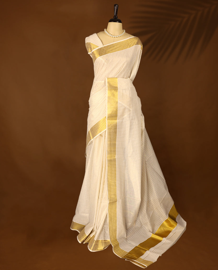 Kerala cotton saree with fine golden stripes and a lustrous zari border with Matching Blouse