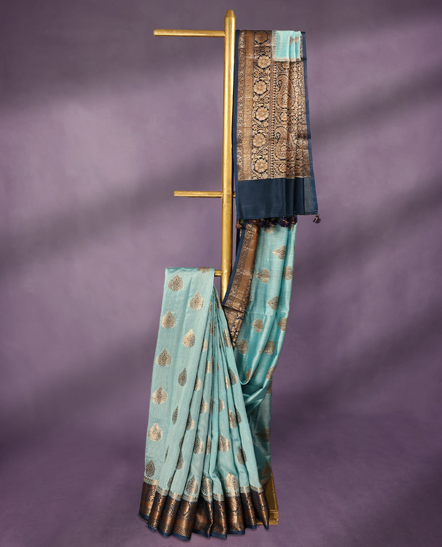 Sky Blue colour pure Banarasi Chanderi cotton fabric, featuring traditional antique zari buttas on the body, complemented by a traditional Indigo Blue Colour border and a matching blouse.