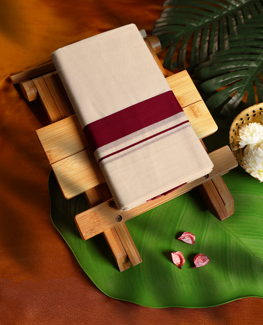 Off white colour cotton double dhoti featuring a striking maroon kara with subtle edging, crafted for traditional grace and everyday comfort, perfect for cultural gatherings and festive occasions.