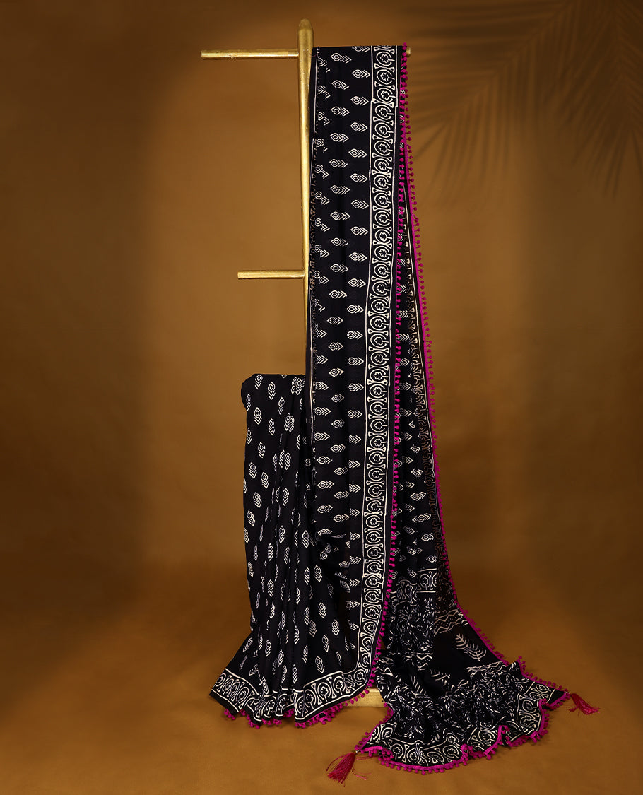 Black cotton saree features intricate white handblock prints, a beautifully detailed border with Pink piping and Self Coloured Blouse