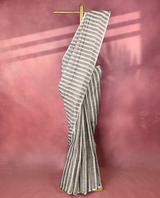 Classic grey and white colour pure linen saree with vertical and horizontal woven stripes all over the body, finished with a simple border, ideal for casual or workwear styling and pairs beautifully with a matching blouse