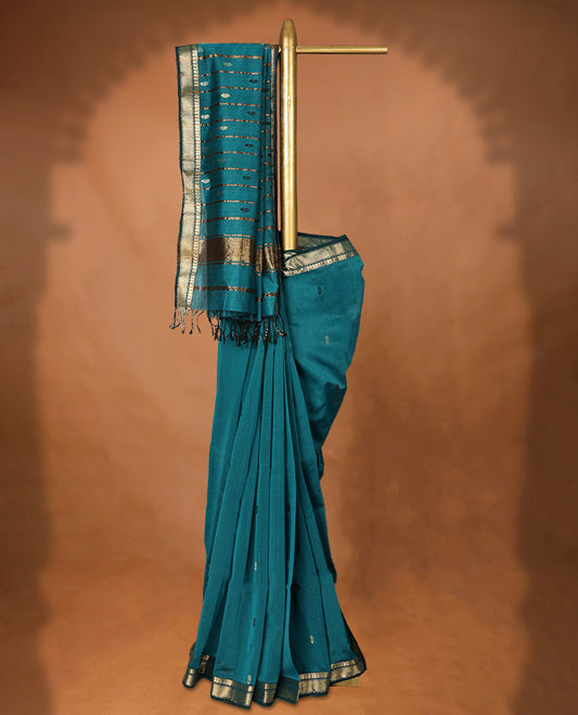 Peacock Blue colour Maheshwari Cotton saree featuring Antique Zari Mango Patterns across the entire body, complemented by a traditional Gold Zari border & Pallu, with a contrast blouse.