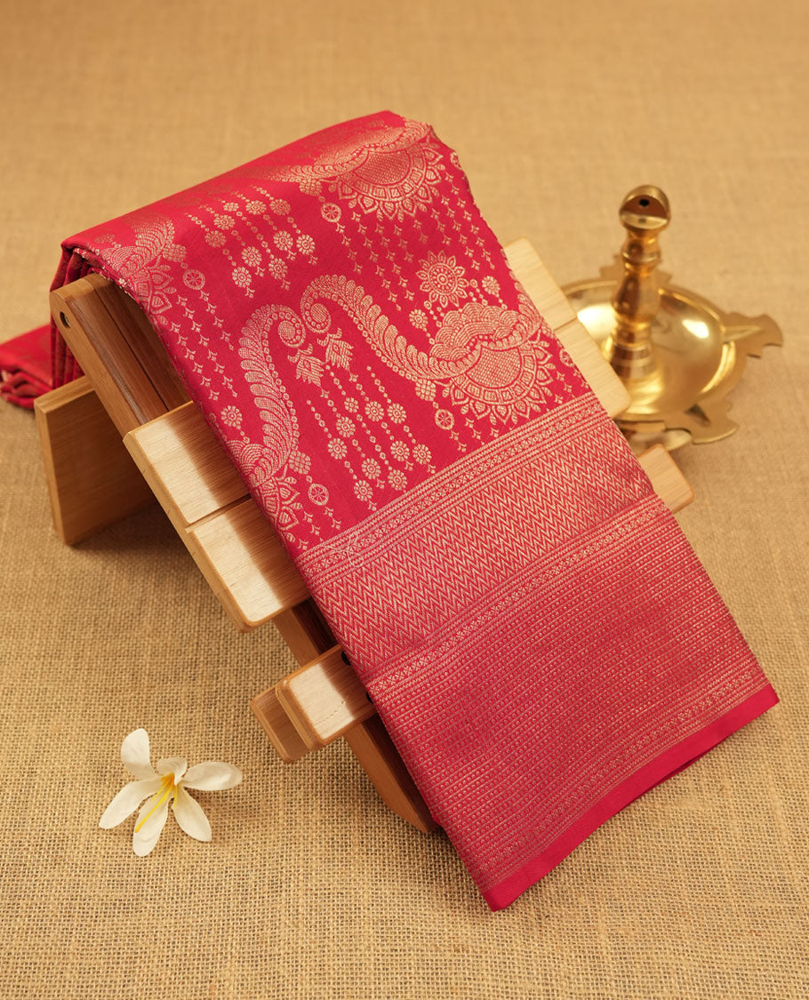 Cherry Red colour Kanchipuram pattern Manthrakodi saree featuring intricate geometric floral antique gold zari weaving design across the body, beautifully complemented with a matching self jaquard blouse piece.