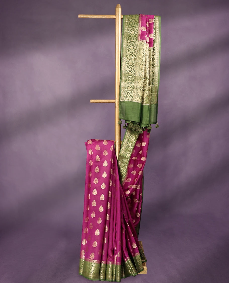 Rani colour pure Banarasi Chanderi cotton fabric, featuring traditional antique zari buttas on the body, complemented by a traditional Green Colour border and a matching blouse.