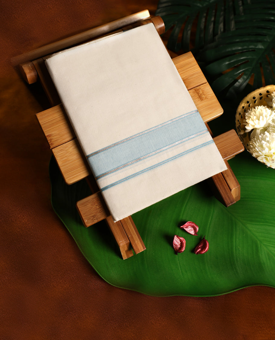 Off white cotton single dhoti featuring a sky blue kara with fine double line edging, crafted for traditional elegance and daily comfort, perfect for rituals, temple visits, and cultural occasions.