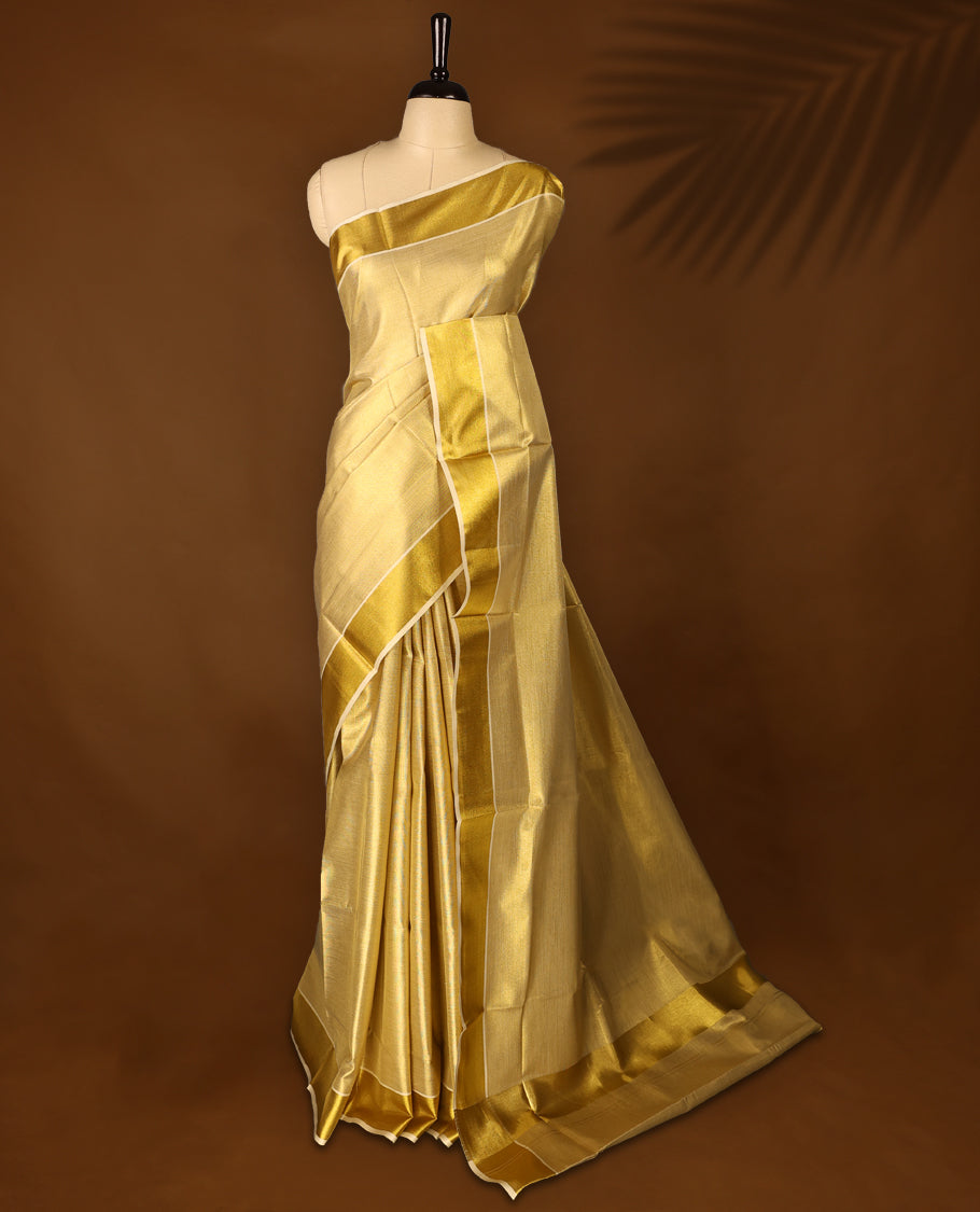 Gold colour Tissue Kerala saree featuring Plain body and a beautifully woven Gold Kasavu border, paired with a matching blouse perfect for festive occasions.