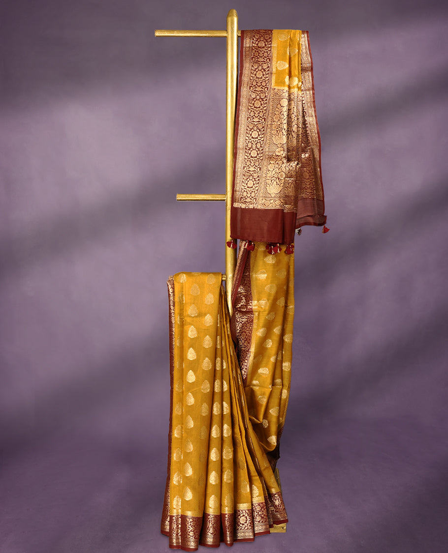 Mustard colour pure Banarasi Chanderi cotton fabric, featuring traditional antique zari buttas on the body, complemented by a traditional Maroon Colour border and a matching blouse.