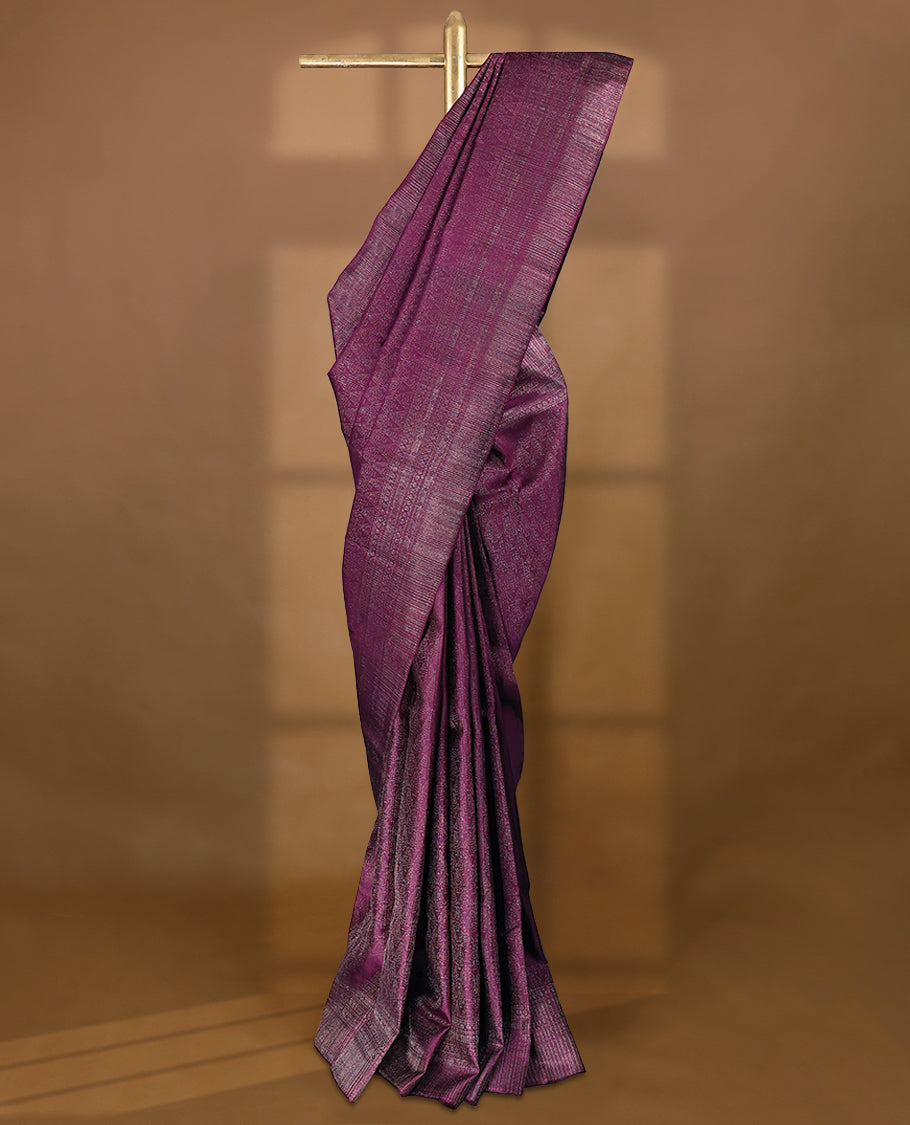 Grape coloured Manthrakodi saree featuring a multicoloured zari jacquard body, complemented by a self coloured turning Banarasi border and a matching self coloured blouse.