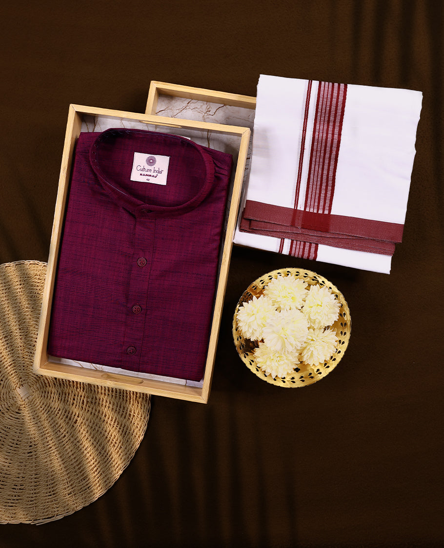 RAMRAJ maroon kurtha paired with a white dhoti, elegantly finished with a matching maroon border.