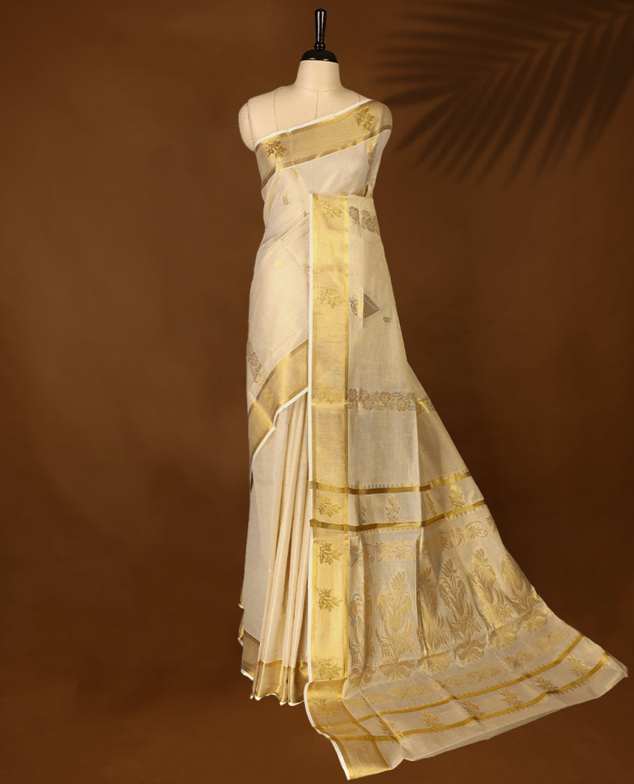 Elegant Light Gold colour Tissue Kerala saree featuring Gold Zari Motifs on body, traditional golden zari kasavu border with Floral Motifs & Rich Pallu offering a classic and graceful look, paired with a matching blouse.