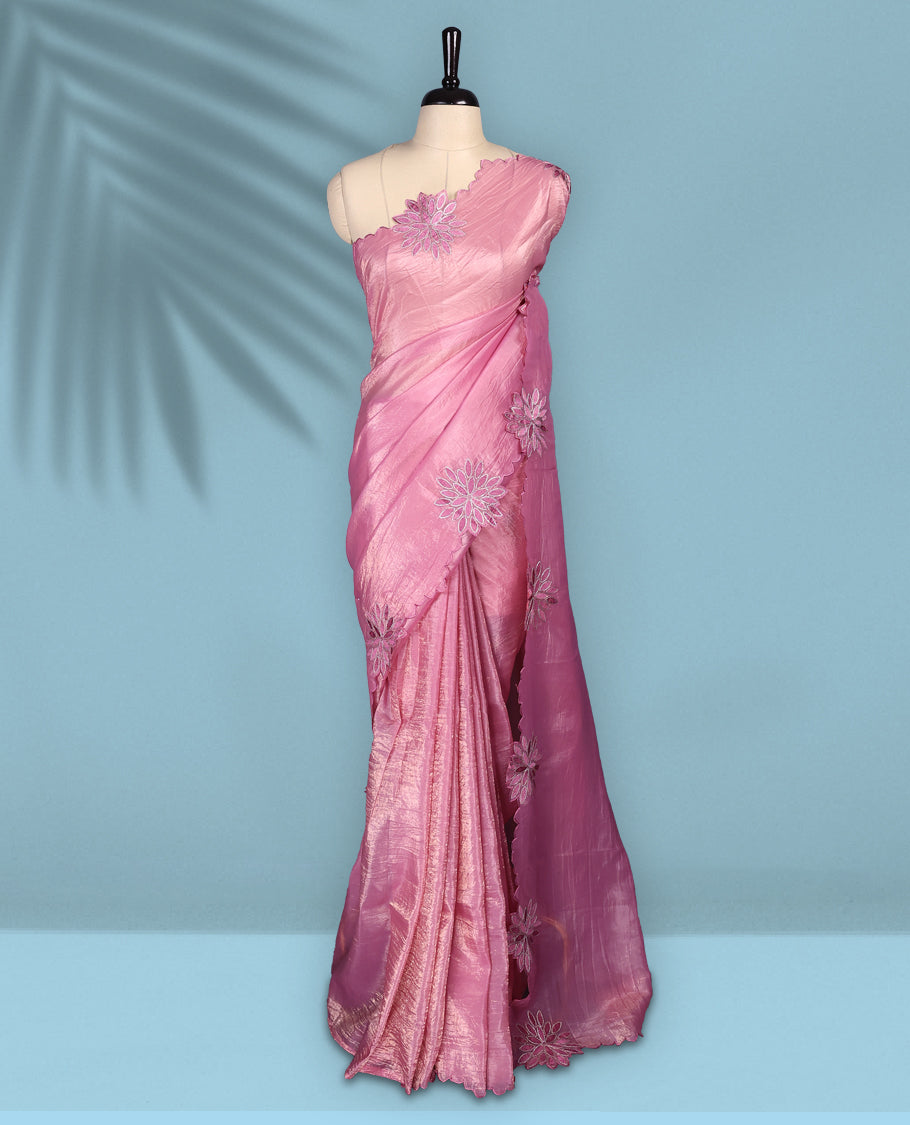 Pink colour crush soft silk saree adorned with bold floral thread embroidery on the body and scallop edged borders, Paired with a matching blouse for a complete look.