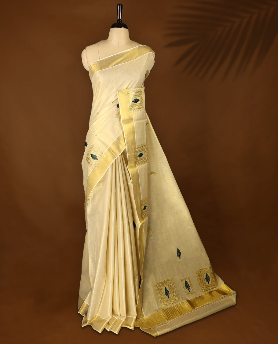 Light Gold colour Tissue Kerala saree featuring Embroidery work on body and a beautifully woven Gold Kasavu border, paired with a matching blouse perfect for festive occasions.
