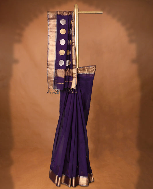 Purple colour Maheshwari Cotton saree featuring Antique Zari bindi Patterns across the entire body, complemented by a traditional Gold Zari border & Pallu, with a matching blouse.