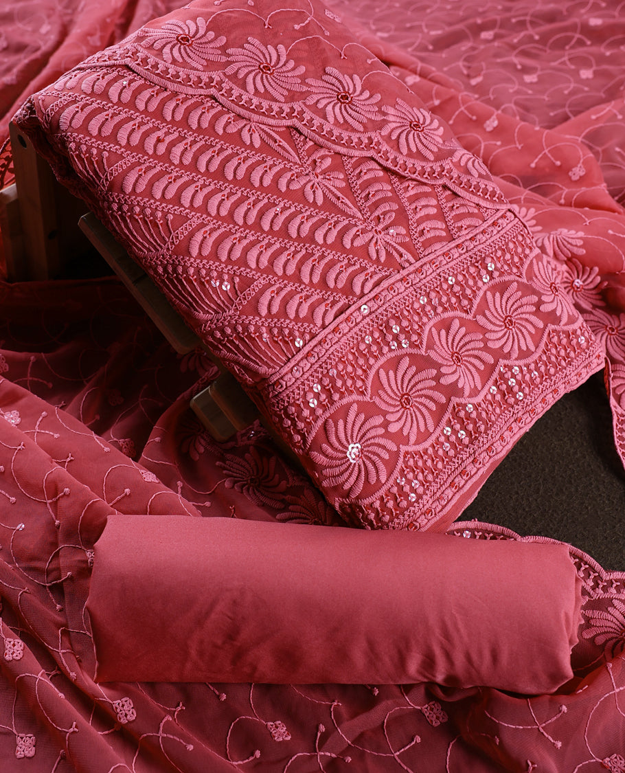 Rose wine colour churidhar material adorned with intricate floral embroidery and sequin highlights, paired with a plain matching bottom and beautifully embroidered dupatta, perfect for festive celebrations and graceful occasions.