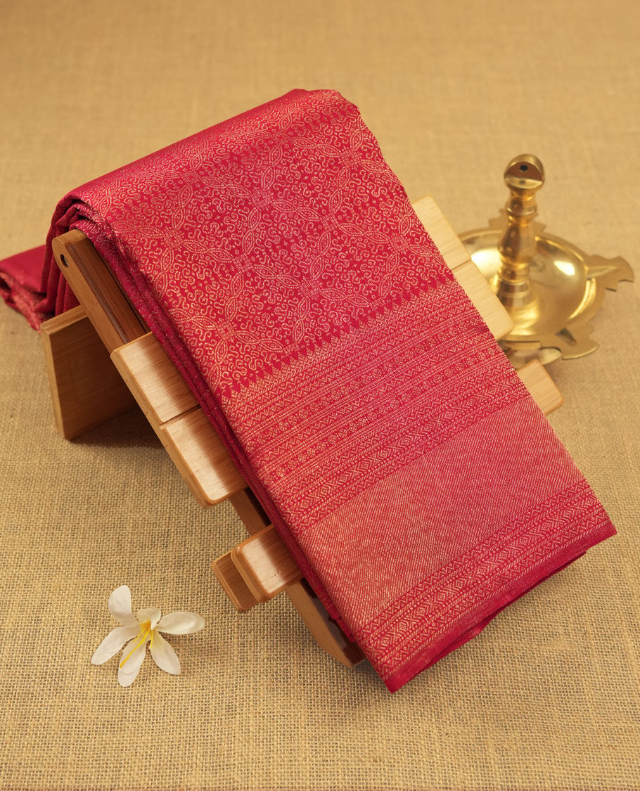 Maroon colour Kanchipuram pattern Manthrakodi saree adorned with antique zari jacquard work featuring elegant geometrical patterns across the body, complemented by a matching jacquard blouse piece for a regal finish.