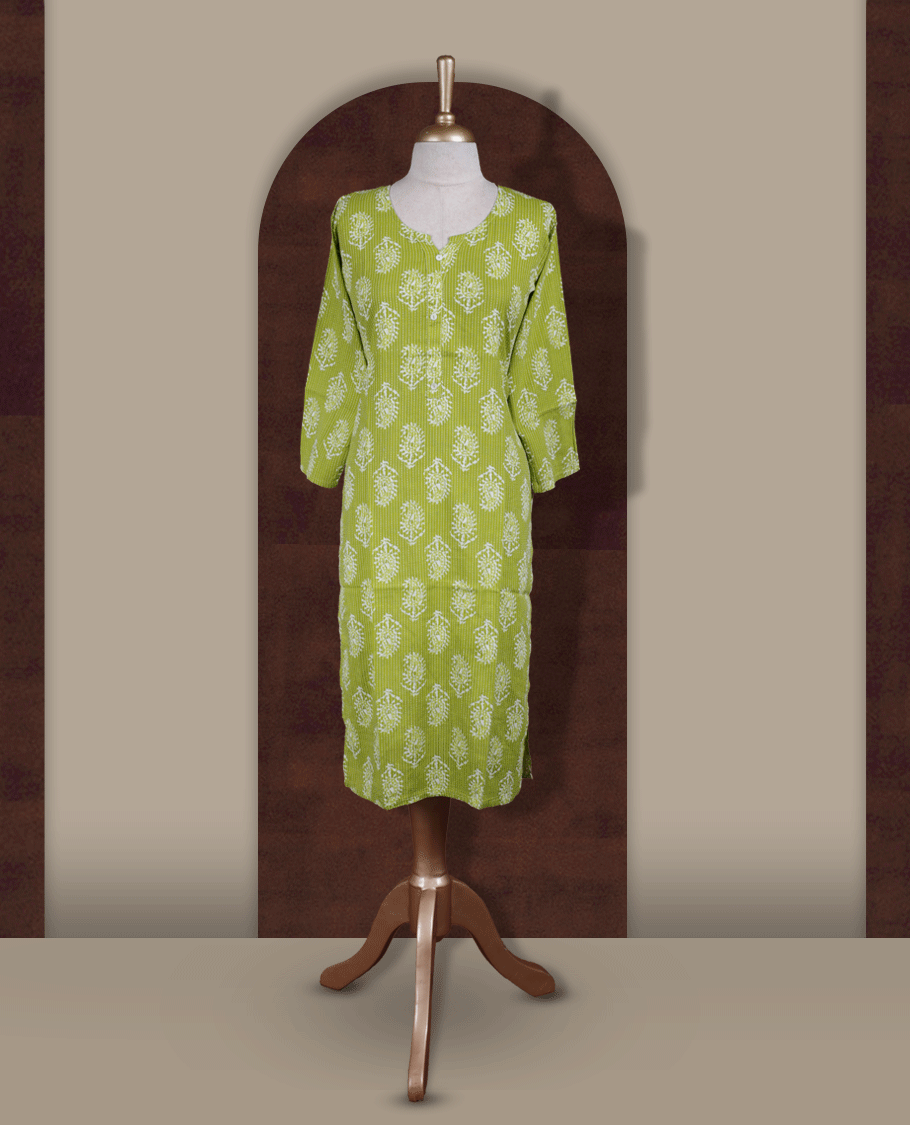Light green colour printed kurti with round notch neck design and button detailing, straight 3/4th sleeves, and all-over white block floral prints.