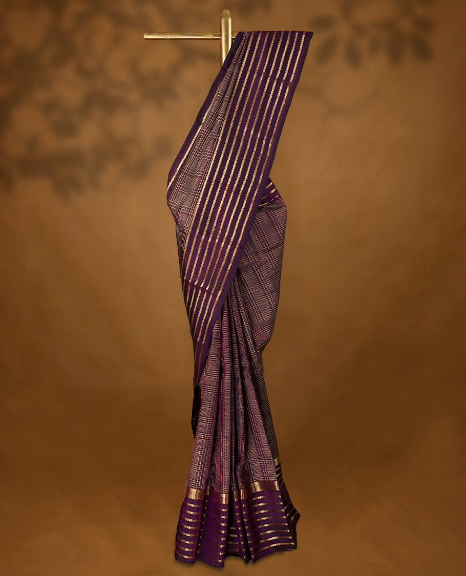 Grape wine Colour soft silk saree adorned with golden zari checks on the body, complemented by a self-coloured border featuring a golden zari Poun design, paired with a matching self-coloured blouse