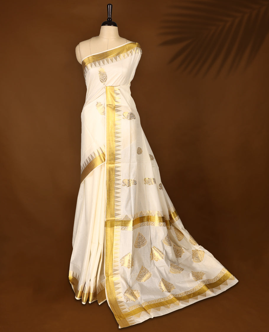 Elegant off white colour cotton Kerala saree featuring Gold zari Bold motifs on body, traditional golden zari kasavu border & Rich Pallu offering a classic and graceful look, paired with a matching blouse.