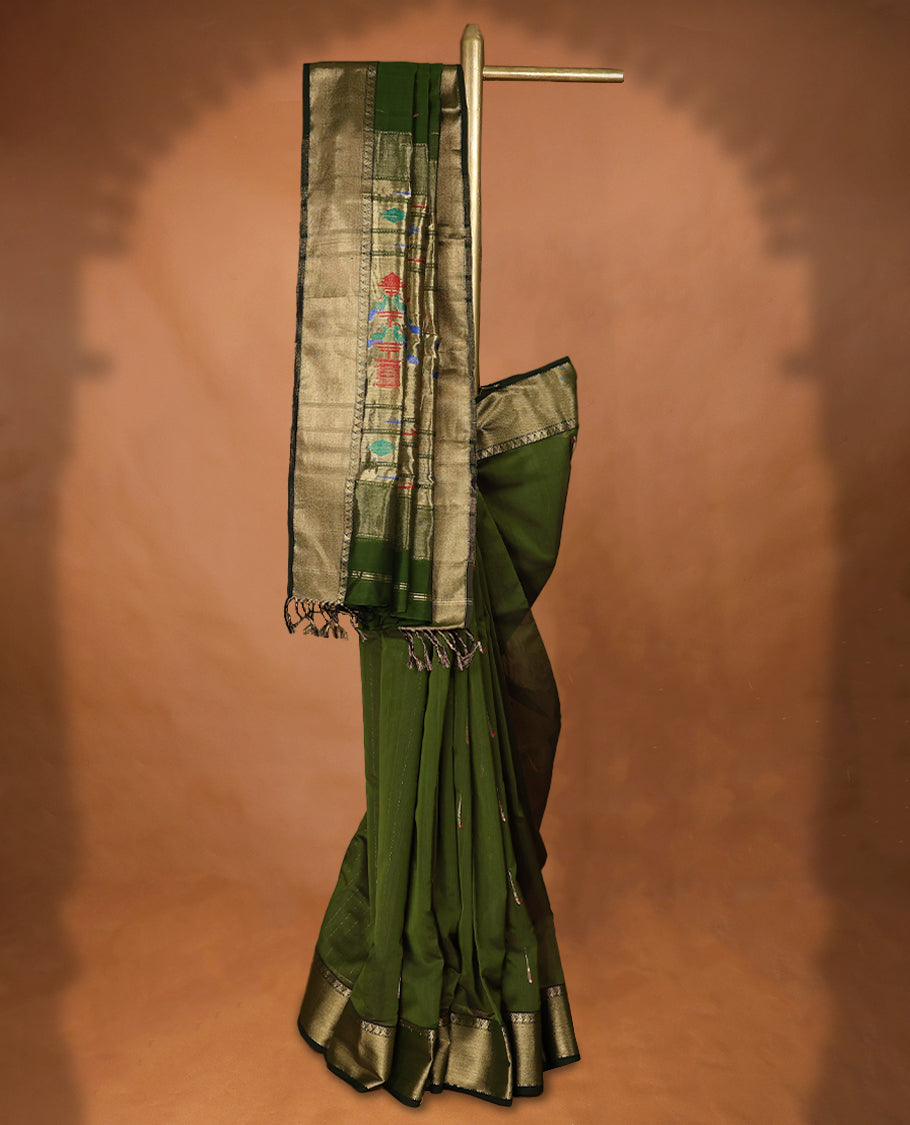 Olive Green coloured Maheshwari Cotton saree featuring antique Zari motifs across the entire body, complemented by a traditional gold coloured border and a matching blouse.