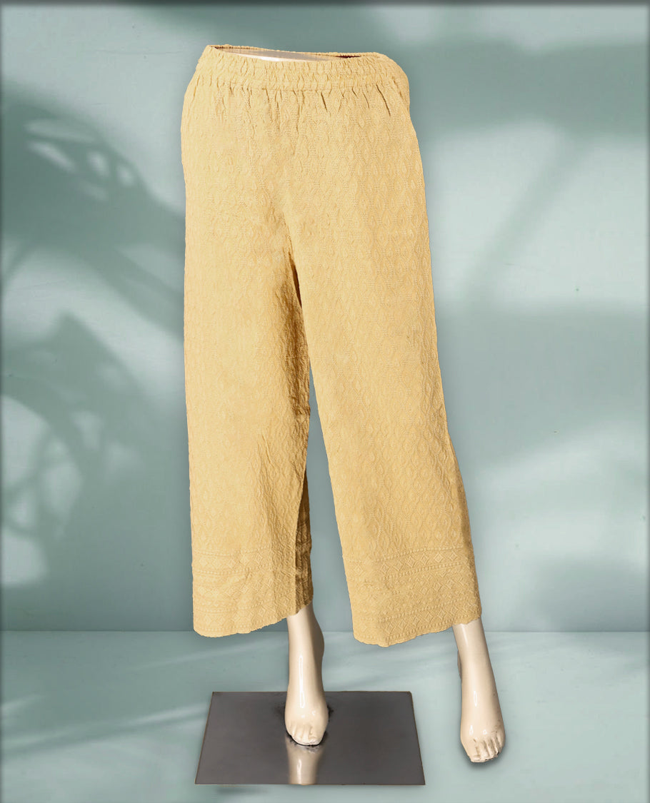 Beige colour palazzo pants featuring intricate self embroidery and a relaxed, flowy fit