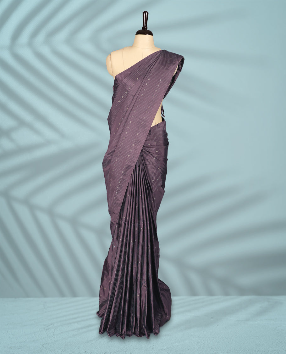 Mauve Colour semi silk saree features subtle square and stripe motifs across the body, comes without a border and paired with a matching blouse.