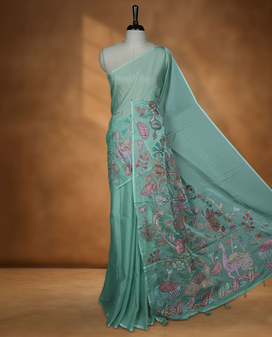 Mint green colour organza saree with multicolour thread embroidery on the pallu and fine border detailing, paired with a matching blouse.