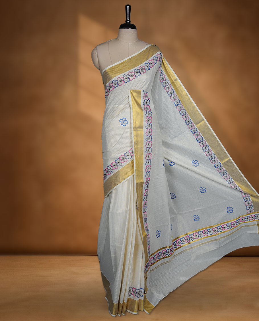 Off-white colour kerala saree featuring pink and purple colour floral border detailing with gold kasavu accents, complemented by a matching blouse piece.