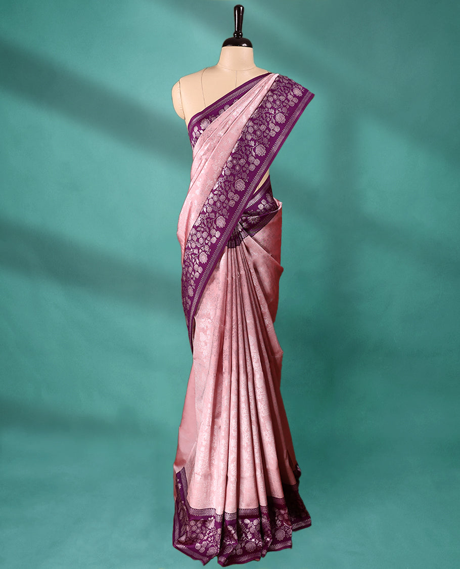 Light Onion coloured semi silk saree featuring a Silver coloured floral jaal design on the body, paired with a Grape coloured border and matching blouse.