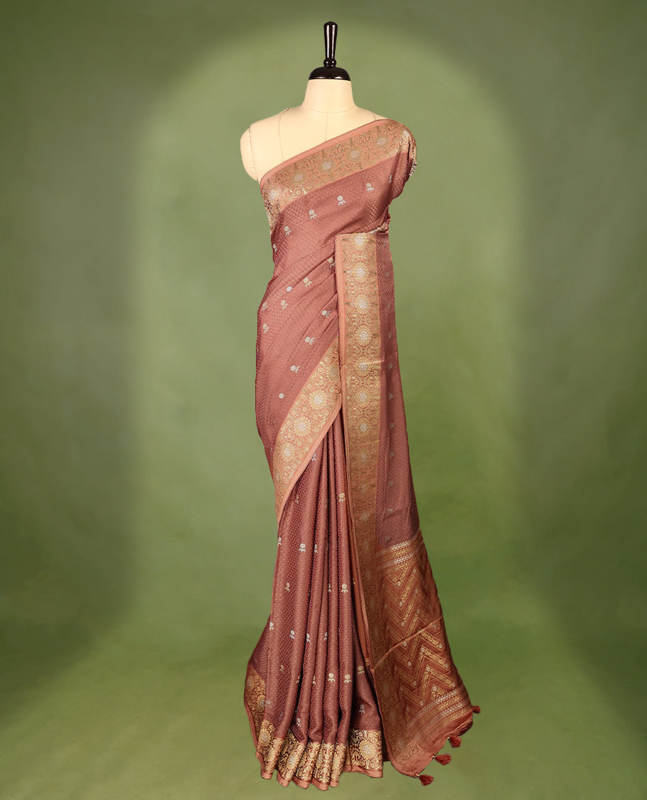 Deep Pastel Brown colour pure Banaras crepe saree showcases elegant silver zari Flower Motifs all over the body, a traditional Banarasi gold zari border, a rich intricately woven pallu, and comes with a matching blouse.