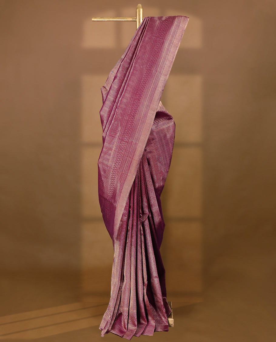 Grape wine Colour Manthrakodi saree featuring an antique zari brocade body, complemented by a self coloured traditional border and a matching self coloured brocade blouse.