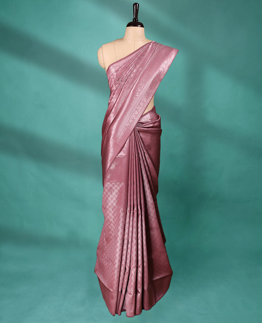 Pastel Onion coloured semi silk saree featuring a Silver coloured Zari Diamond design on the body, paired with a Self coloured border and matching blouse.