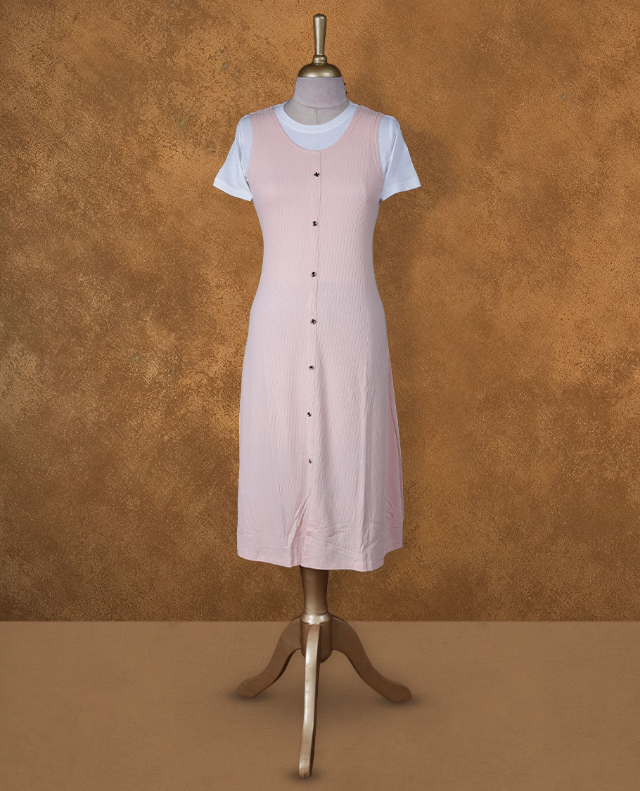 Blush pink sleeveless A-line midi dress with front button detailing, layered over a white crew-neck short-sleeve inner tee