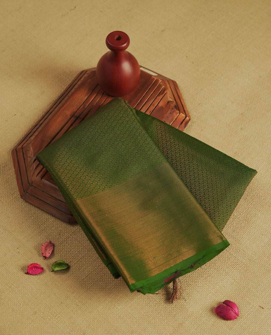Green colour semi silk saree featuring neem zari Brocade Pattern all over the body, complemented by a Self Colour woven border with detailing with contrast Red Colour Pallu & blouse.