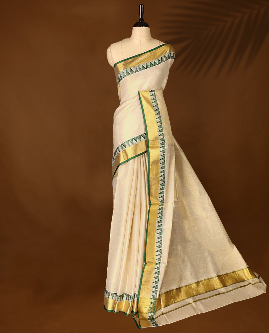Elegant Light Gold colour Tissue Kerala saree featuring Plain body and traditional golden zari kasavu border with Green colour temple work offering a classic and graceful look, paired with a matching blouse.