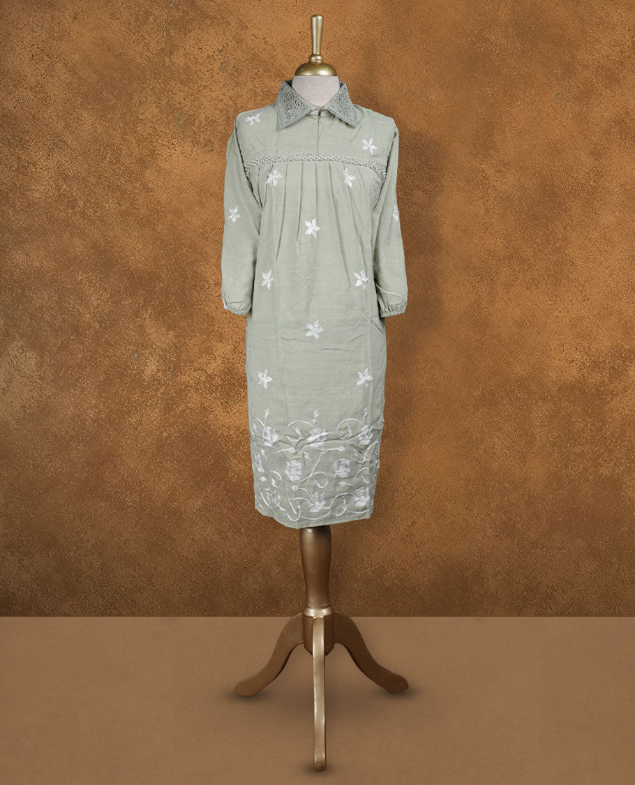 Sage green embroidered nightwear kurti with crochet-detailed shirt collar, scattered white floral motifs, heavy floral hem embroidery, and three-quarter sleeves with elasticated cuffs