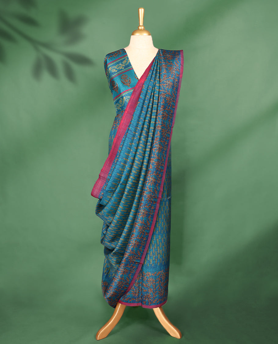 Light Blue Colour Manipuri saree features a brick patterned body in olive hues, beautifully offset by a contrasting magenta border with copper floral-printed, and comes with a matching blouse.