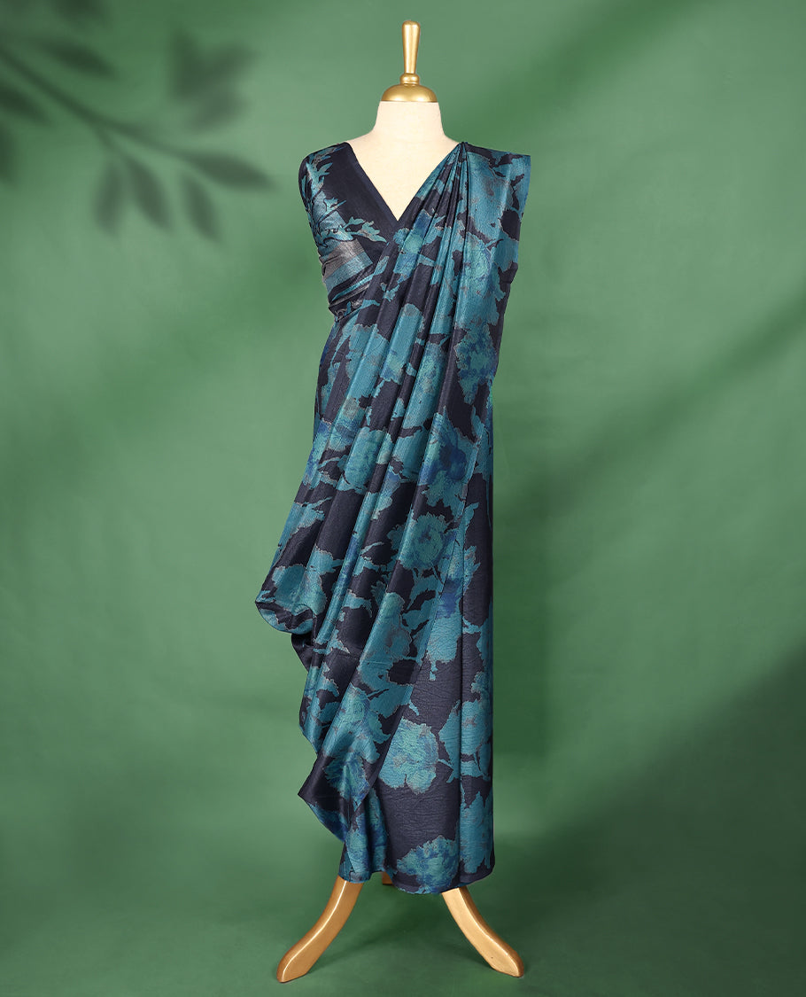 Midnight blue colour Manipuri saree featuring oversized teal floral motifs, finished without a border, and paired with a matching blouse.