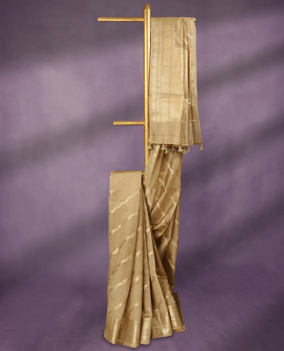 Beige colour pure Banarasi Chanderi cotton, beautifully adorned with traditional antique zari Cross Kodi designs across the body, completed with a hand-dyed colour, a traditional border, and a matching blouse.