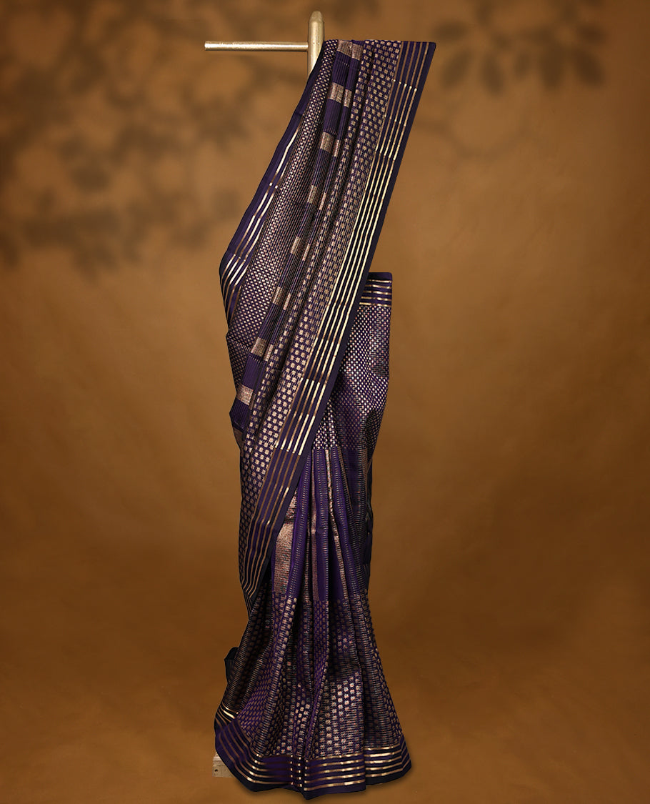 Dark purple Colour soft silk saree adorned with antique zari work, featuring a self-coloured floral border and paired with a matching blouse.