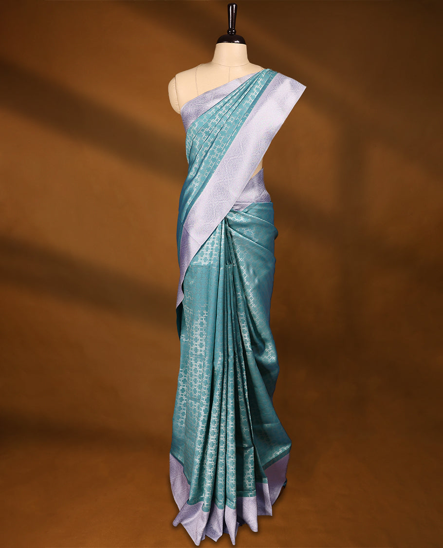 Aqua Green coloured semi silk saree featuring a Silver coloured Zari design on the body, paired with a Baby Blue coloured border and matching blouse.