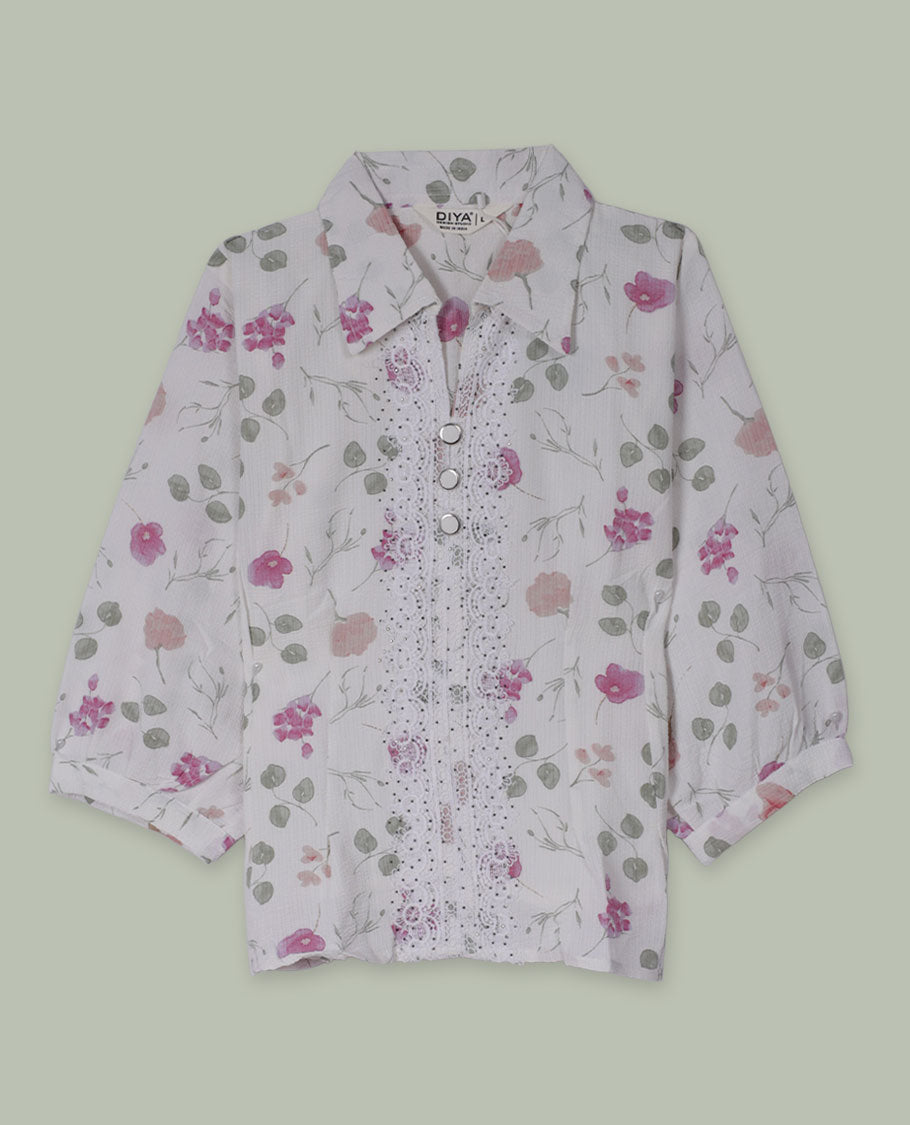 White floral printed shirt top with collared neckline, three-quarter sleeves, and front button placket framed by embroidered lace detailing.